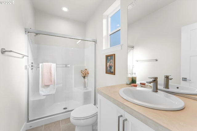 bathroom featuring vanity, toilet, a shower with door, and tile patterned flooring