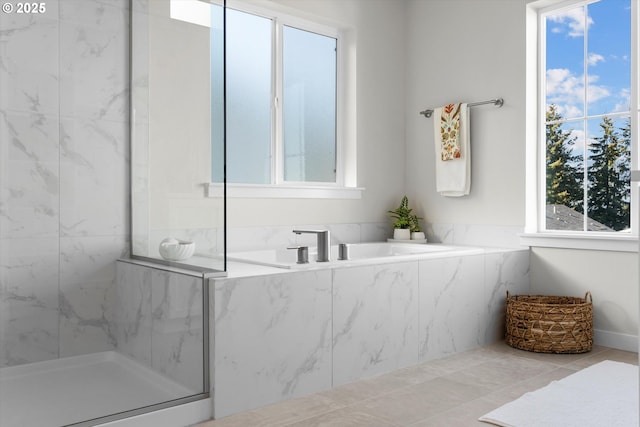 bathroom featuring tile patterned flooring and separate shower and tub