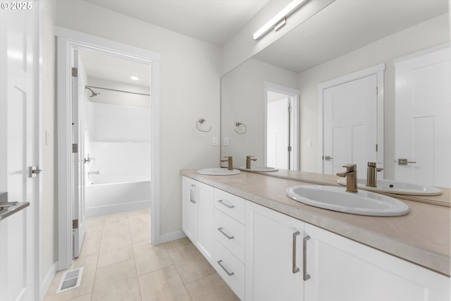 bathroom featuring vanity, tile patterned flooring, and shower / tub combination