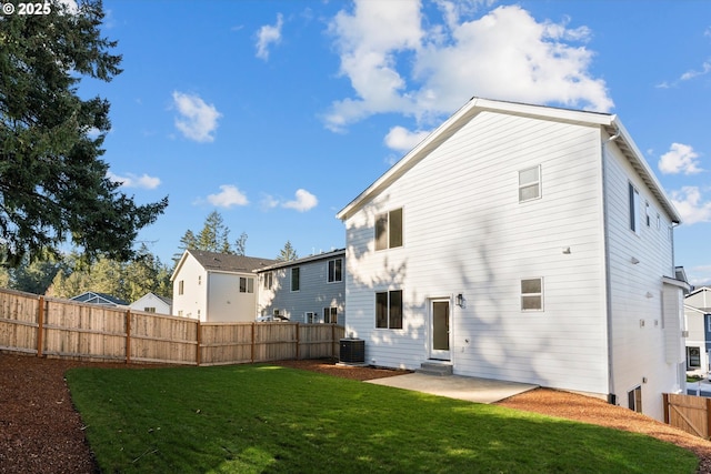 back of house with a patio, central AC, and a lawn