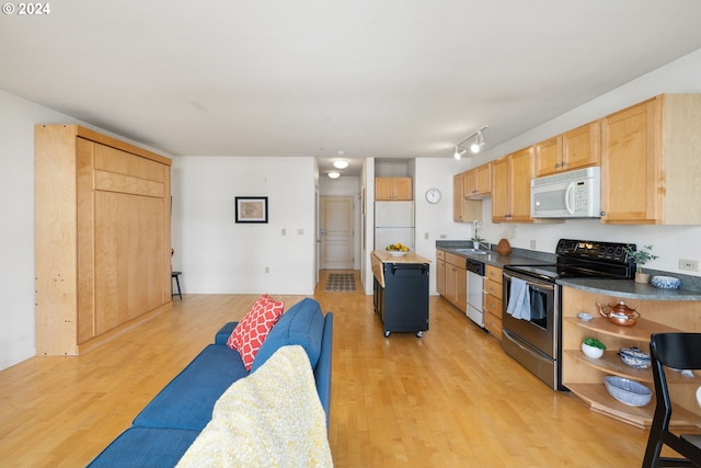 kitchen with light hardwood / wood-style flooring, sink, stainless steel appliances, track lighting, and light brown cabinets