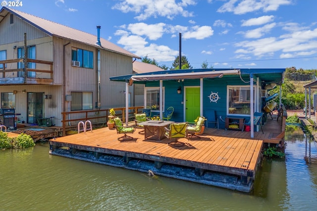 rear view of property featuring a water view and a balcony