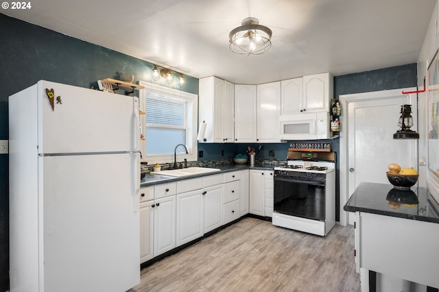 kitchen featuring white cabinets, light wood-type flooring, white appliances, and sink