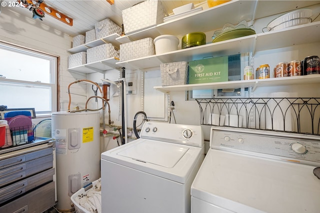 clothes washing area with separate washer and dryer and water heater