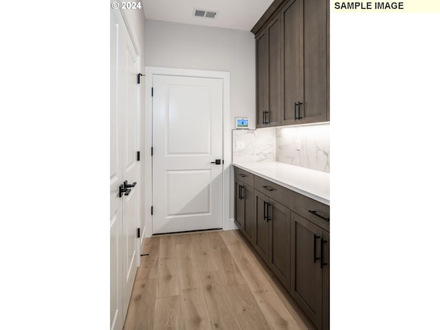 laundry room with light hardwood / wood-style floors