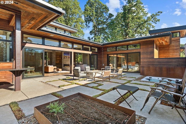 view of patio with a garden and an outdoor living space