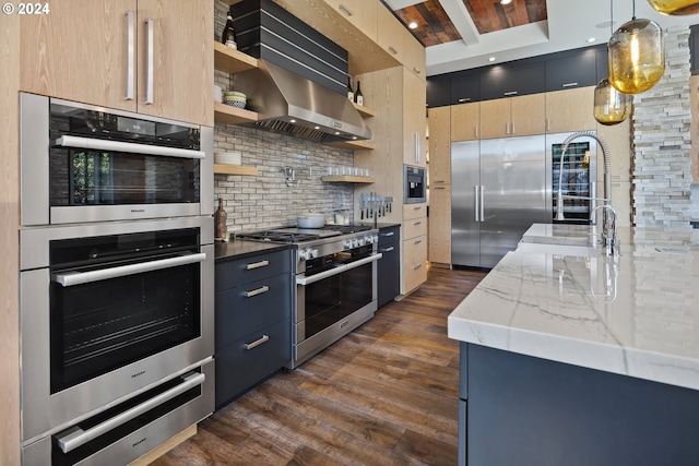 kitchen with open shelves, high quality appliances, light stone countertops, dark wood-type flooring, and backsplash