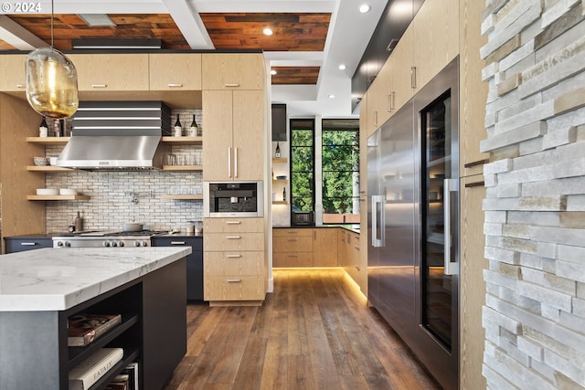 kitchen with dark wood-type flooring, stainless steel appliances, light stone countertops, decorative light fixtures, and light brown cabinetry