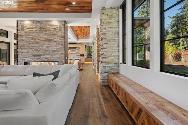 living area with dark wood-type flooring, recessed lighting, wooden ceiling, and a fireplace