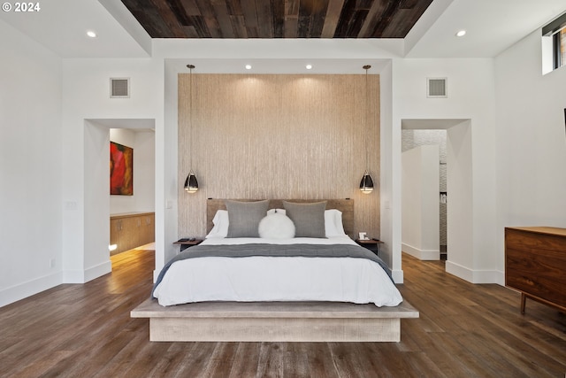 bedroom with a high ceiling, wood ceiling, and dark hardwood / wood-style floors