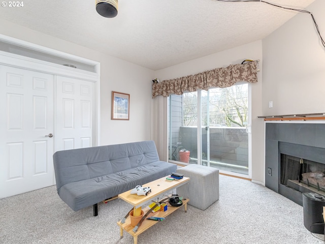 living room with a textured ceiling and light colored carpet