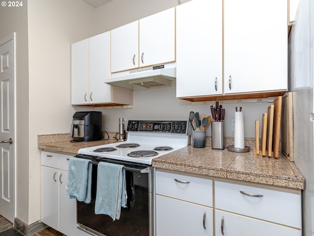 kitchen with white cabinets and white electric stove