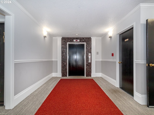 entrance foyer with wood-type flooring, a textured ceiling, elevator, and crown molding