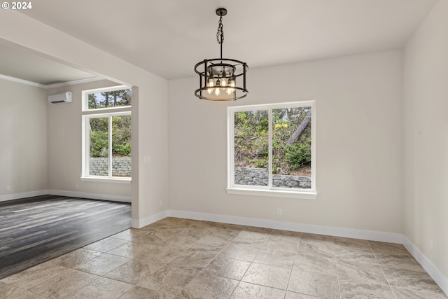 unfurnished room with crown molding, a wall mounted air conditioner, and a chandelier