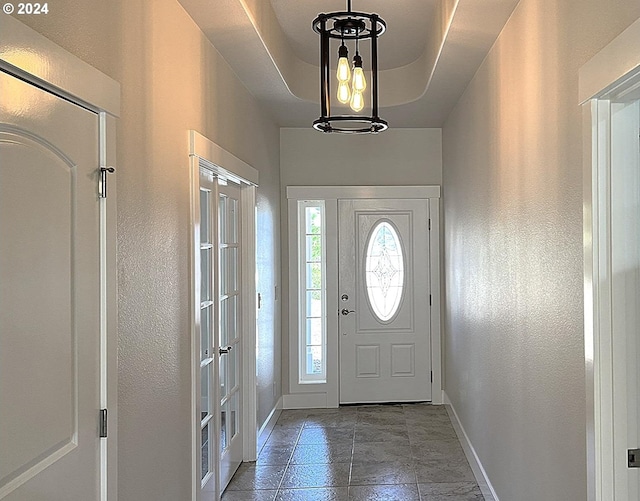 entryway featuring a raised ceiling