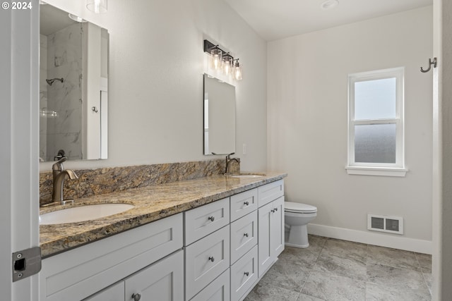 bathroom with walk in shower, vanity, and toilet