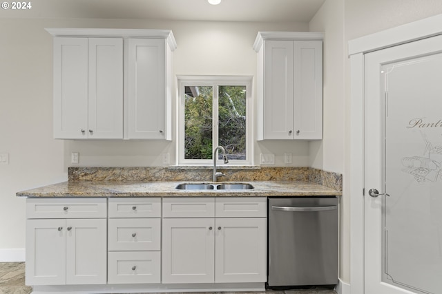 kitchen featuring white cabinetry, dishwasher, light stone countertops, and sink