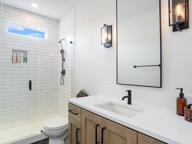 bathroom with a shower with door, vanity, and toilet