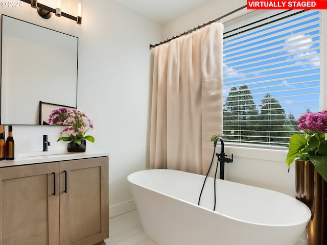 bathroom featuring vanity, a bathing tub, and tile patterned floors