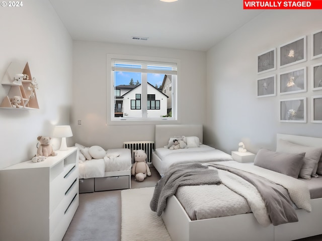 carpeted bedroom featuring radiator