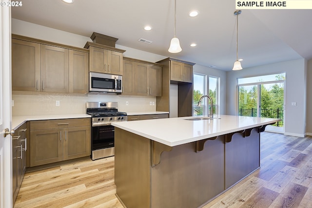 17374 SW Kalapuya Ln Unit 70, Sherwood, OR 97140 - kitchen with stainless steel appliances, a sink, light wood-style flooring, recessed lighting, and decorative backsplash