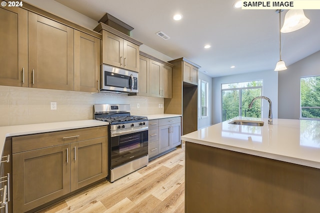 17374 SW Kalapuya Ln Unit 70, Sherwood, OR 97140 - kitchen featuring appliances with stainless steel finishes, a sink, light wood-type flooring, light countertops, and recessed lighting