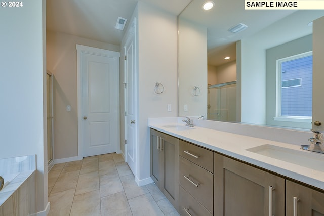 17374 SW Kalapuya Ln Unit 70, Sherwood, OR 97140 - bathroom with a stall shower, tile patterned floors, double vanity, baseboards, and a tub to relax in