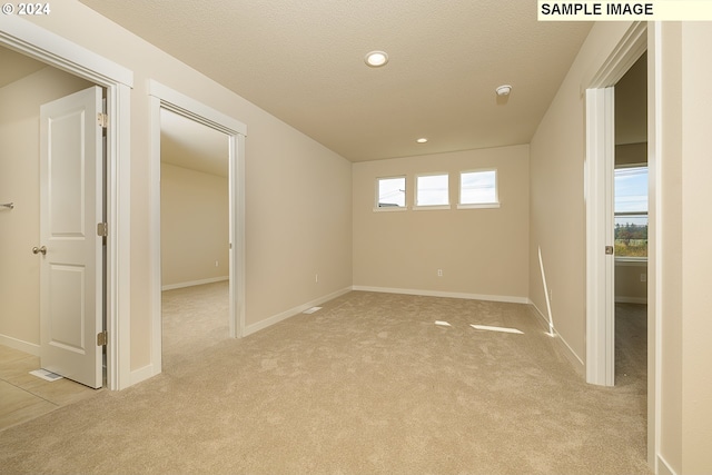 17374 SW Kalapuya Ln Unit 70, Sherwood, OR 97140 - empty room featuring light carpet, a textured ceiling, baseboards, and recessed lighting
