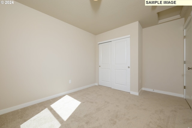 17374 SW Kalapuya Ln Unit 70, Sherwood, OR 97140 - unfurnished bedroom with light colored carpet, baseboards, and a closet