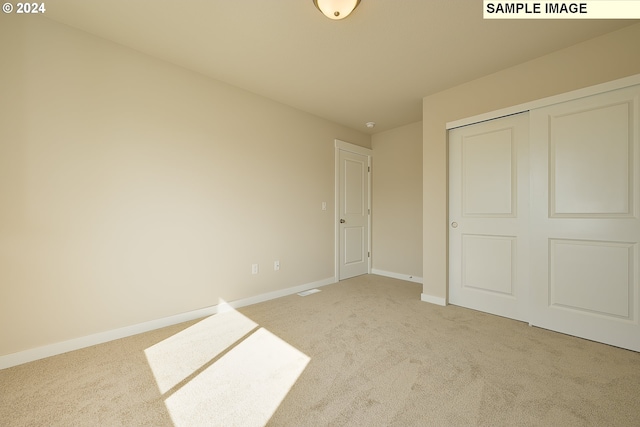17374 SW Kalapuya Ln Unit 70, Sherwood, OR 97140 - unfurnished bedroom featuring light colored carpet, baseboards, and a closet