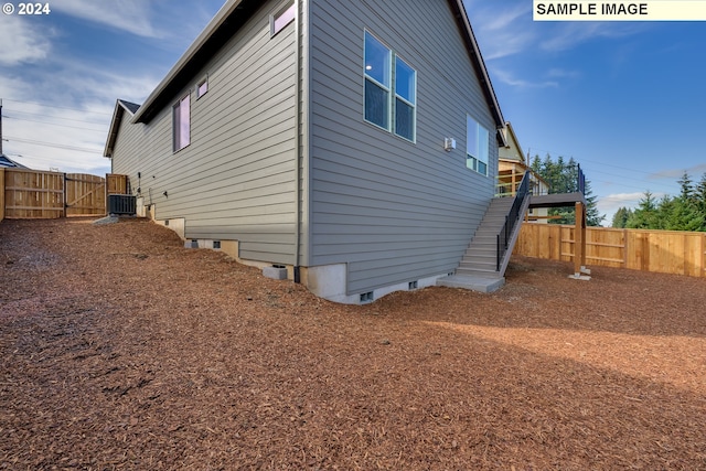 17374 SW Kalapuya Ln Unit 70, Sherwood, OR 97140 - view of side of property with stairway, a fenced backyard, central AC unit, and crawl space