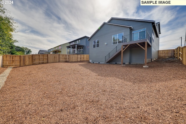 17374 SW Kalapuya Ln Unit 70, Sherwood, OR 97140 - rear view of house with stairs, a fenced backyard, and a wooden deck
