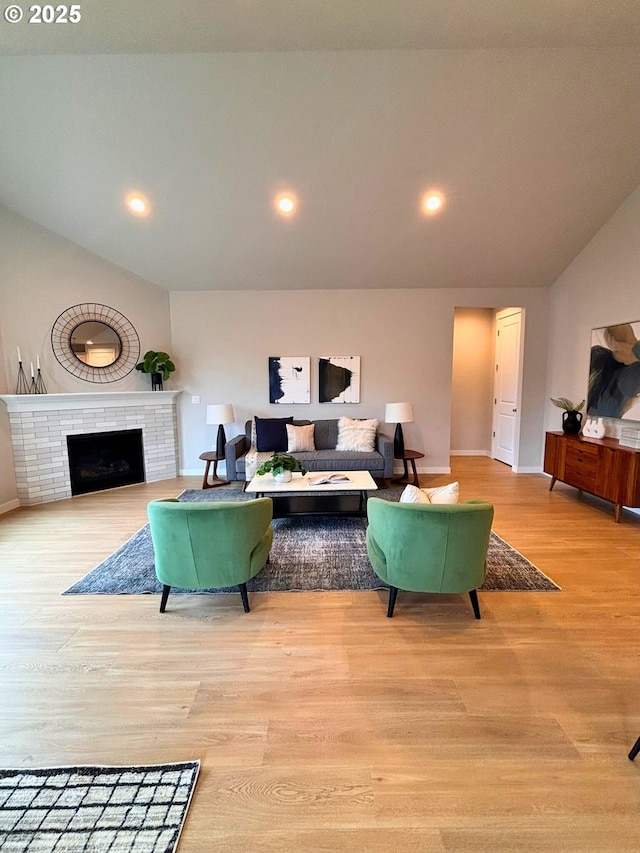 17374 SW Kalapuya Ln Unit 70, Sherwood, OR 97140 - living area with vaulted ceiling, light wood-style floors, a tiled fireplace, baseboards, and recessed lighting