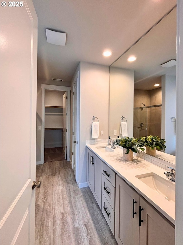 17374 SW Kalapuya Ln Unit 70, Sherwood, OR 97140 - full bathroom with a stall shower, wood finished floors, double vanity, a spacious closet, and recessed lighting