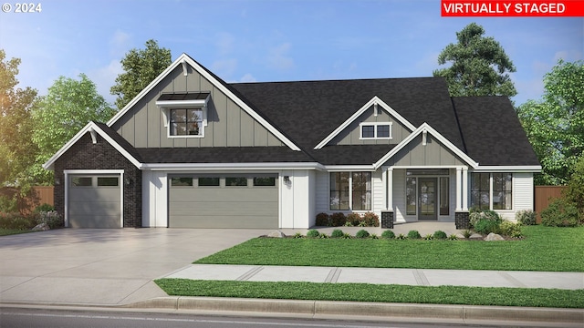 craftsman house featuring a garage and a front lawn