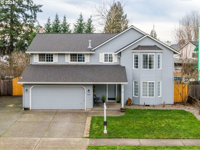 view of front property featuring a front lawn and a garage