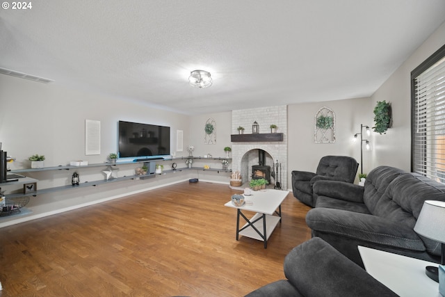 living room with a textured ceiling and hardwood / wood-style floors