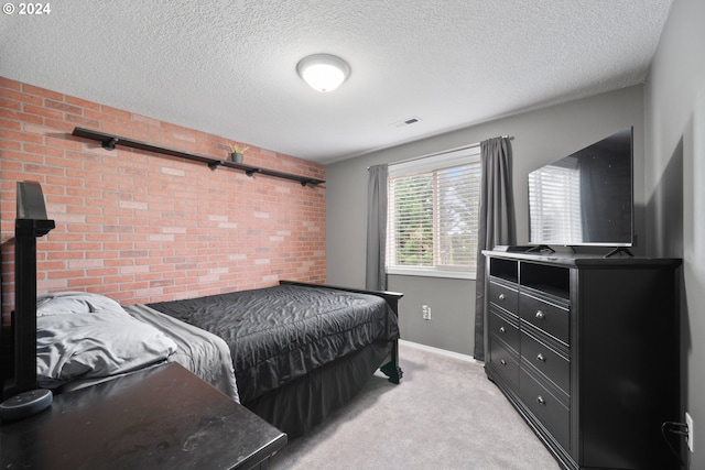 bedroom with a textured ceiling and light carpet