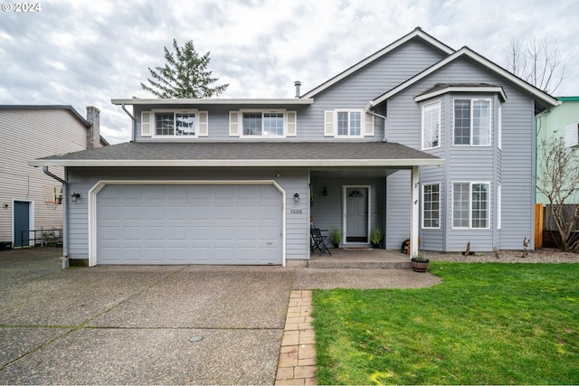 front facade featuring a front lawn and a garage