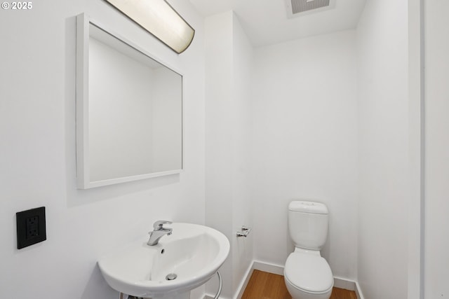 1025 NW Couch St Unit 716, Portland, OR 97209 - half bath with a sink and wood finished floors