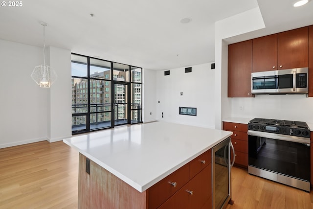 1025 NW Couch St Unit 716, Portland, OR 97209 - kitchen featuring stainless steel appliances, wine cooler, light wood-style flooring, floor to ceiling windows, and light countertops