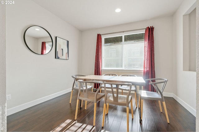 dining area with dark hardwood / wood-style flooring