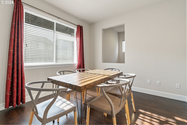 dining space with dark wood-type flooring