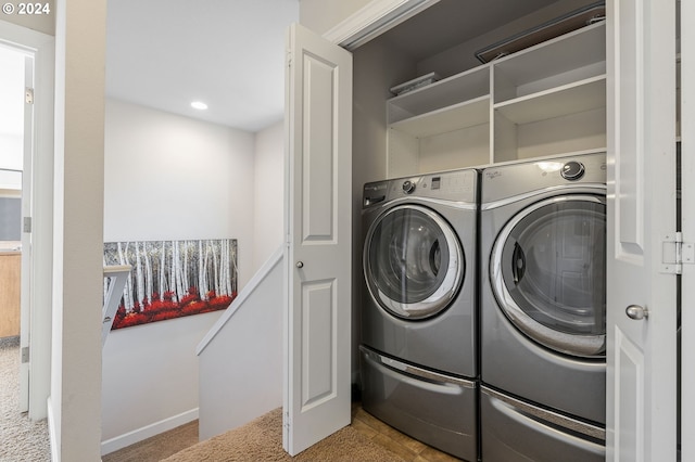 laundry room with independent washer and dryer and light carpet