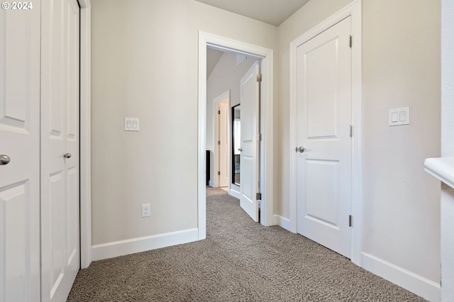 hallway with carpet floors