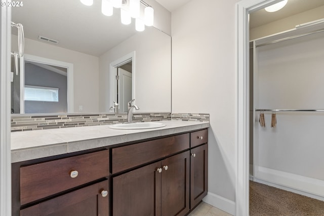 bathroom featuring decorative backsplash and vanity