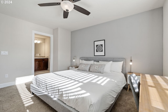 carpeted bedroom with ceiling fan and ensuite bath