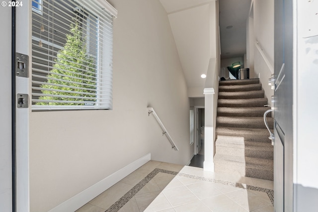 stairs featuring tile patterned flooring