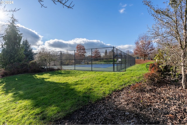 view of sport court featuring a yard