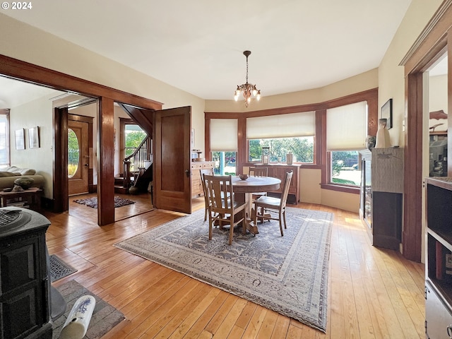 dining space with light wood-type flooring and an inviting chandelier